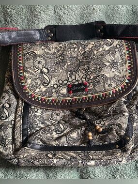 Sakroots Black and Cream Floral Canvas convertible backpack with Colorful Trim